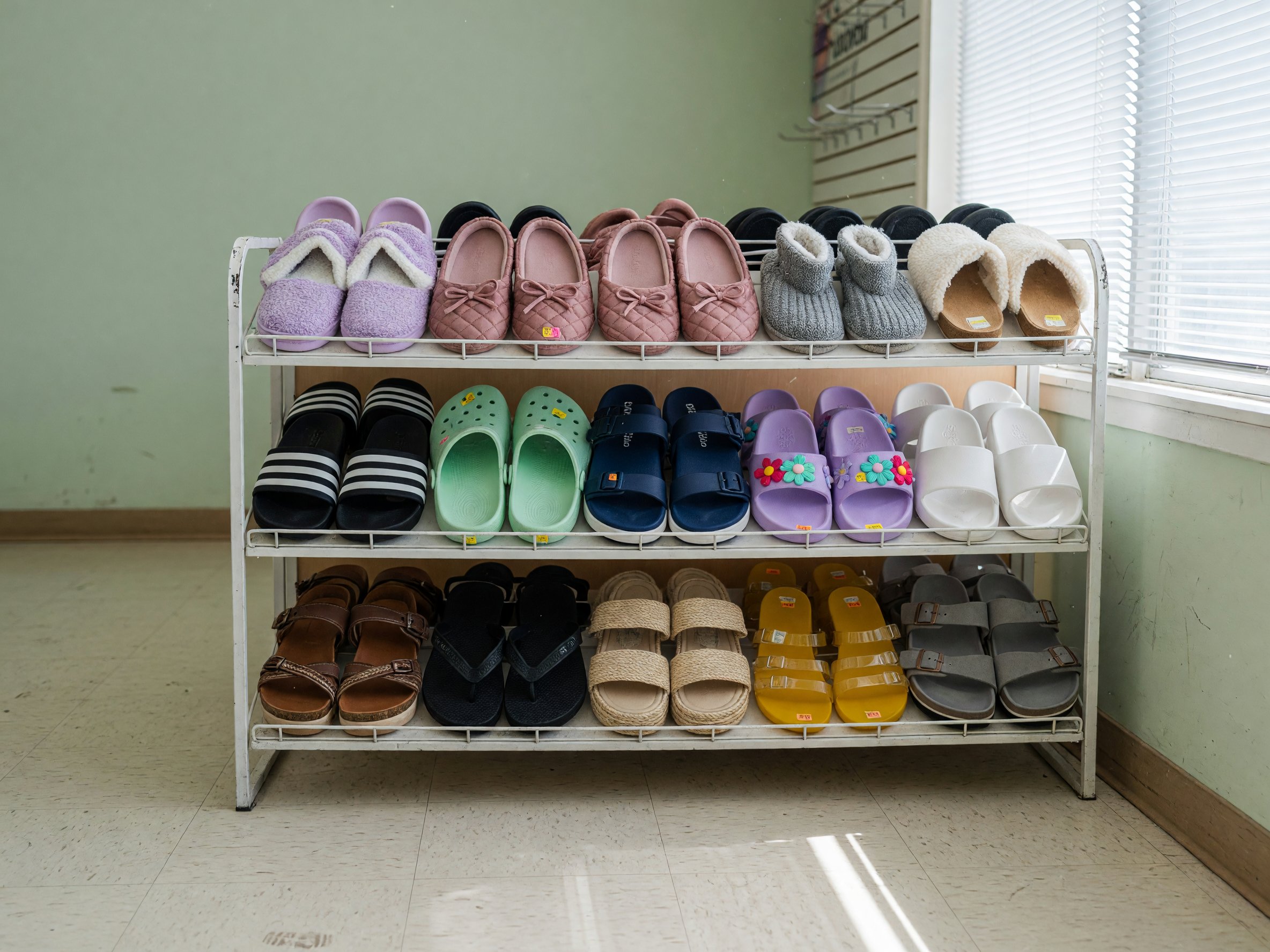 Casual footwear on a low retail rack.