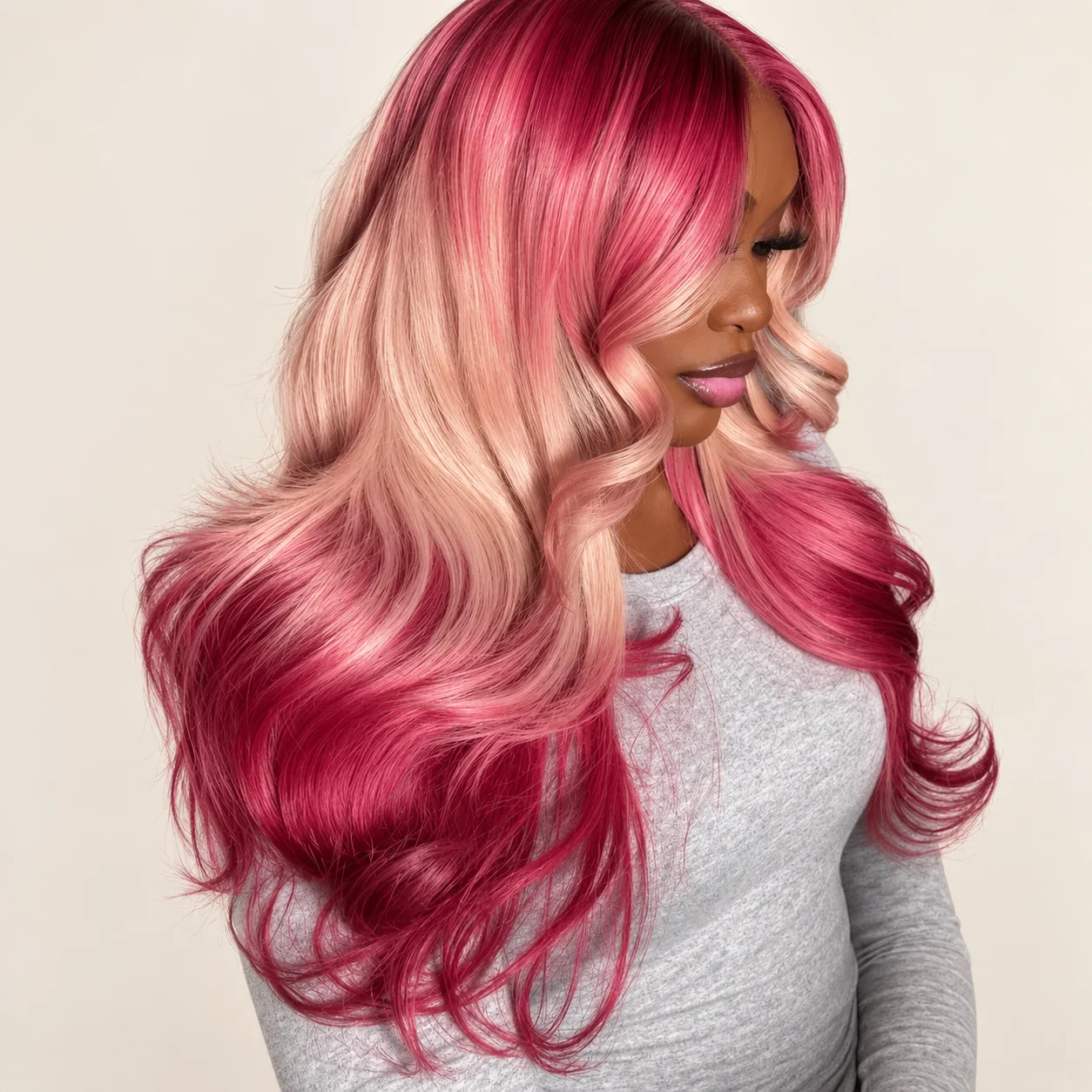 Long wavy wig fading from deep pink to blonde, worn by a model