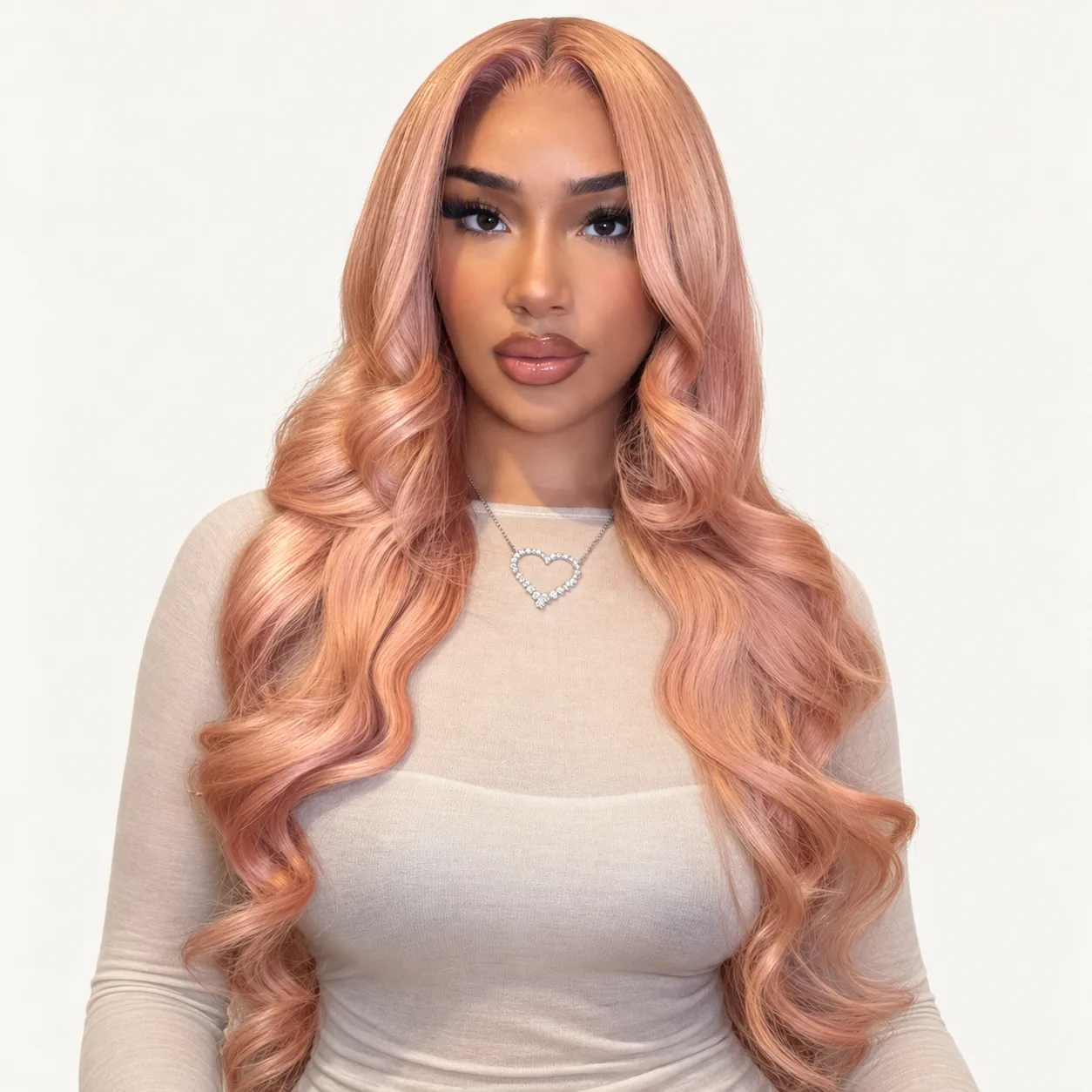 Long wavy wig in a soft rose-blush pink, worn by a model
