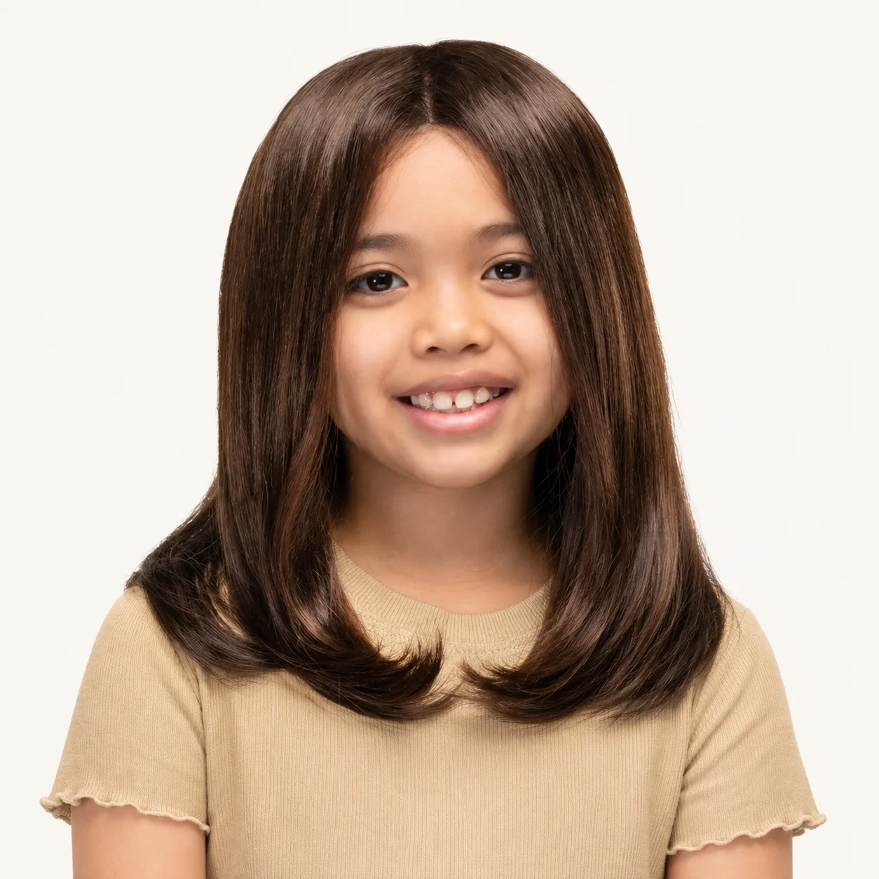 Child wearing a shoulder-length brown medical wig